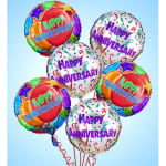 Cluster of colorful anniversary balloons with confetti patterns