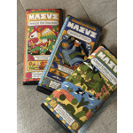 Three colorful wrapped chocolate bars with illustrated designs on a fabric surface