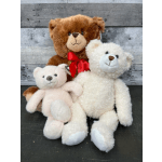 Three plush teddy bears with a red ribbon