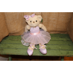 Plush teddy bear in a lavender tutu and satin bow