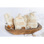 Canvas bags of caramel candies in a wooden bowl