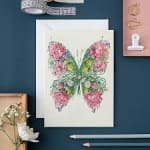 Butterfly illustration made of pink flowers on a white card