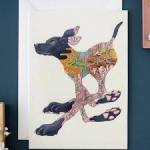 Framed artwork of a dog made from colorful patterned sections