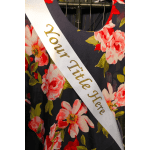 Floral-print dress with a white sash reading "Your Title Here"