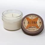 Two soy candles in glass jars, one with a labeled lid