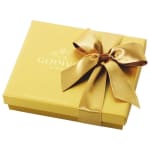 Gold gift box with a satin ribbon bow