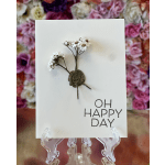 White greeting card with small dried flowers and "OH HAPPY DAY" text