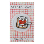 Enamel pin on a card with a heart and the words Spread Love