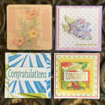 Four floral congratulations cards with pastel and bright flower designs