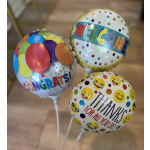 Three colorful foil balloons with welcome, congrats, and thanks messages