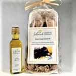 Gourmet gift set with small bottle of oil and clear bag of baking mix tied with raffia bow