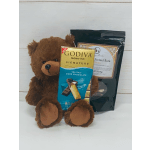 Brown teddy bear with a Godiva dark chocolate bar and a bag of pretzel bark candy.