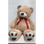 Large tan teddy bear with a red ribbon bow