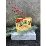 Whitman's chocolate sampler boxes decorated with evergreen sprigs and red berries