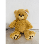 Plush teddy bear sitting on a light surface