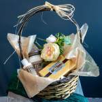 Gift basket with a flower, candle, lotion, and candy box