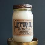 White candle in a glass jar with a metal lid