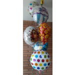 Cluster of birthday balloons with colorful patterns and emoji faces