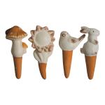 Four small ceramic animal figurines with orange cone bases