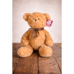 Plush teddy bear with a checkered bow and hanging tag