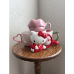 Hello Kitty mugs on a wooden table