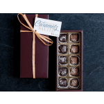 Rectangular gift box of salted caramels with ribbon and open tray showing assorted chocolates.