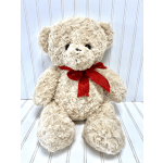 Cream teddy bear with a red ribbon bow