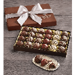 Box of assorted chocolate truffles with a ribbon and a small tray of chocolates