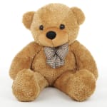 Tan teddy bear with a checkered bow tie on a white background