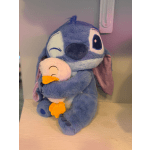 Blue plush character holding a small white duck plush