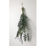 Hanging bundle of eucalyptus and lavender tied with string against a plain wall