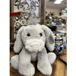 Gray plush donkey toy sitting on a wooden surface