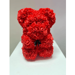 Red rose teddy bear on a white surface