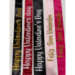 Five Valentine-themed satin ribbons with gold lettering laid side by side.