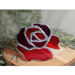 Red stained-glass rose on a wood slice