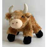 Plush toy cow with white horns and black hooves