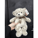 Plush teddy bear with a ribbon bow and hanging tag