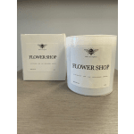Two white flower shop candles with boxed packaging
