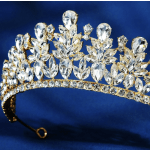 Crystal tiara with gold-toned metal on a blue background