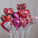 Cluster of heart-shaped Valentine's Day balloons on white sticks
