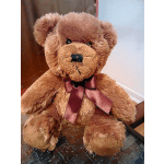 Brown teddy bear with a burgundy ribbon bow