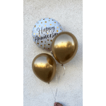 Three balloons, including a happy anniversary balloon and two gold balloons.