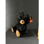 Black plush teddy bear with tan paws and muzzle