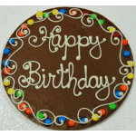 Round chocolate birthday cake with white icing and colorful candy border
