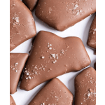 Close-up of irregular milk chocolate pieces sprinkled with coarse salt