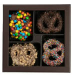 Box of four chocolate-covered pretzels with assorted toppings