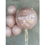 Cluster of pale pink balloons with a large clear balloon and gold bows
