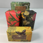 Four decorative soap bars in floral-patterned paper wrappers