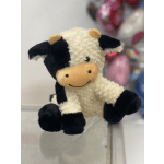 Plush cow toy with black and white fur and a smiling face