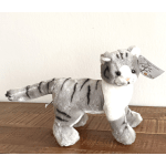 Plush gray-and-white tiger toy standing on a wooden surface